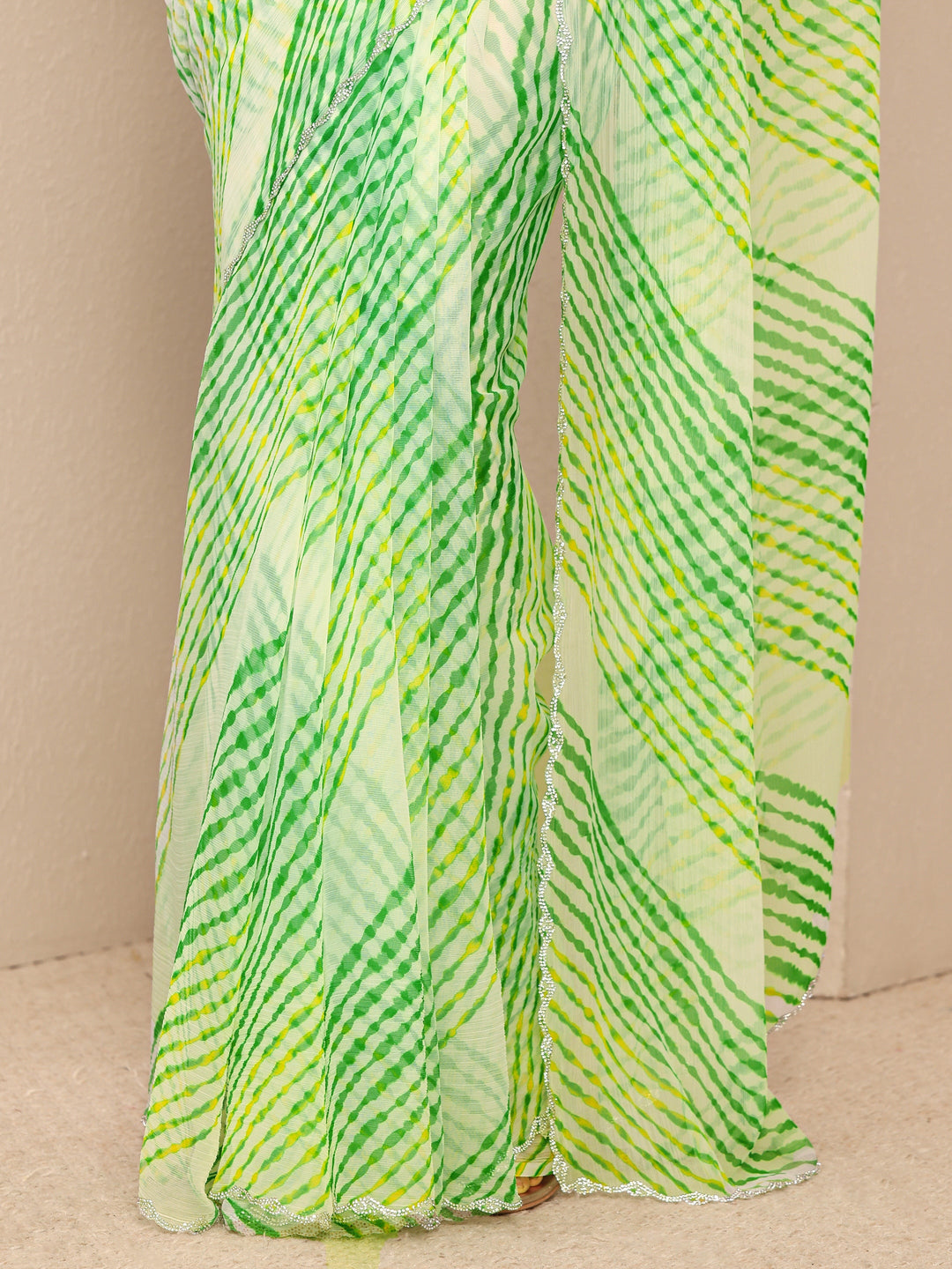  Green Leheriya Printed Chiffon Saree
With Unstitched Blouse Piece 