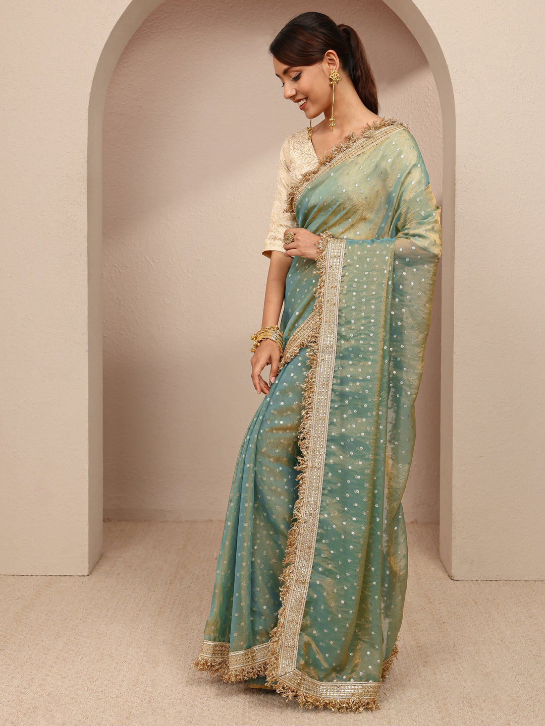  Green Woven Design Tissue Saree
With Unstitched Blouse Piece 